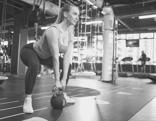 woman working out with kettle bell
